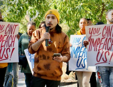 Sergeo Cea speaks during a protest at the Philadelphia Navy Yard, held outside the building where members of the state House of Representatives are holding hearings on the effort to impeach Philadelphia District Attorney Larry Krasner. (Emma Lee/WHYY)