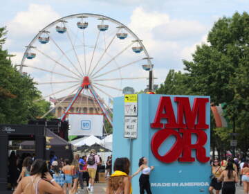 People surround a sign that reads 