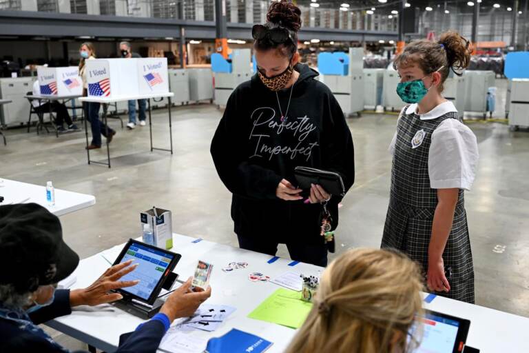 A person checks in at a polling place.