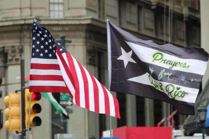 An American flag flies next to a Puerto Rican independence flag that has 