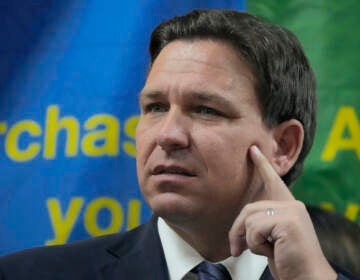 FILE - Florida Gov. Ron DeSantis listens to a question during a press conference Sept. 7, 2022, in Miami, Fla. The Republican governors of Florida and Texas have delivered migrants on planes and buses to Washington, D.C., New York City and even Martha's Vineyard, but they may just be getting started. (AP Photo/Rebecca Blackwell, File)