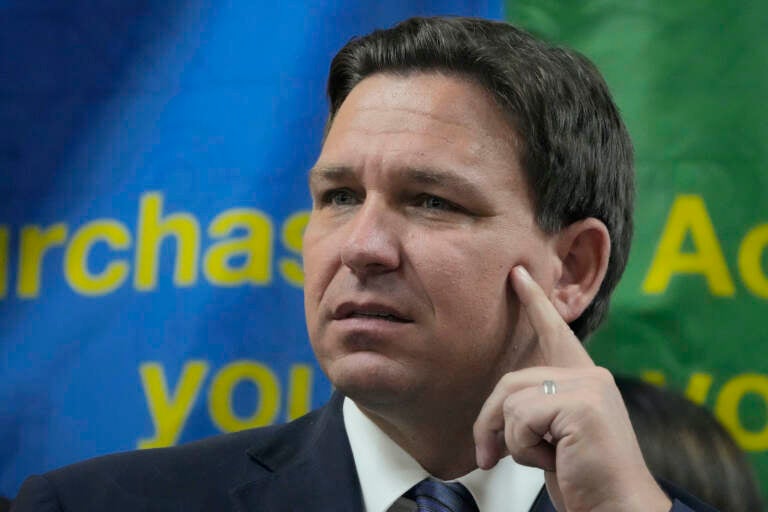 FILE - Florida Gov. Ron DeSantis listens to a question during a press conference Sept. 7, 2022, in Miami, Fla. The Republican governors of Florida and Texas have delivered migrants on planes and buses to Washington, D.C., New York City and even Martha's Vineyard, but they may just be getting started. (AP Photo/Rebecca Blackwell, File)