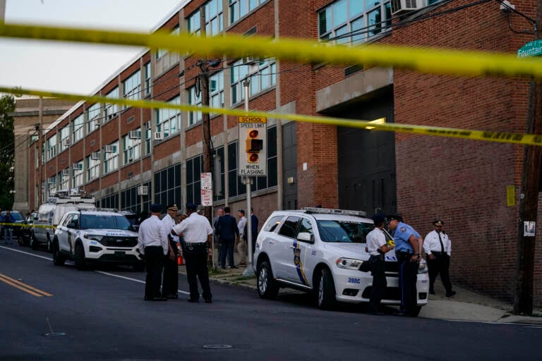 Investigators work the scene where multiple people were shot near a high school in Philadelphia