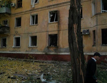 A man walks past a damaged building after a Russian attack in Kramatorsk, Ukraine