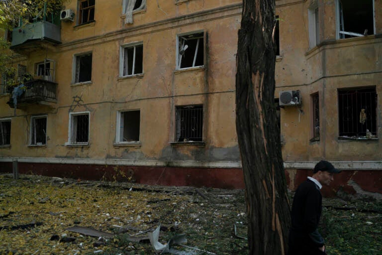 A man walks past a damaged building after a Russian attack in Kramatorsk, Ukraine