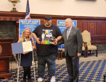 Jeopardy! champion Ryan Long was presented with a ceremonial model of the Liberty Bell at City Hall on September 13, 2022. (Tom MacDonald / WHYY)