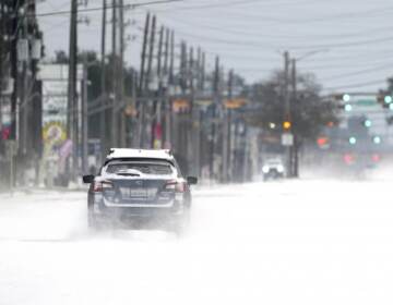 Vehicles drive on snow and sleet covered roads Monday, Feb. 15, 2021, in Spring, Texas. A winter storm dropping snow and ice sent temperatures plunging across the southern Plains, prompting a power emergency in Texas a day after conditions canceled flights and impacted traffic across large swaths of the U.S. (David J. Phillip / AP Photo)
