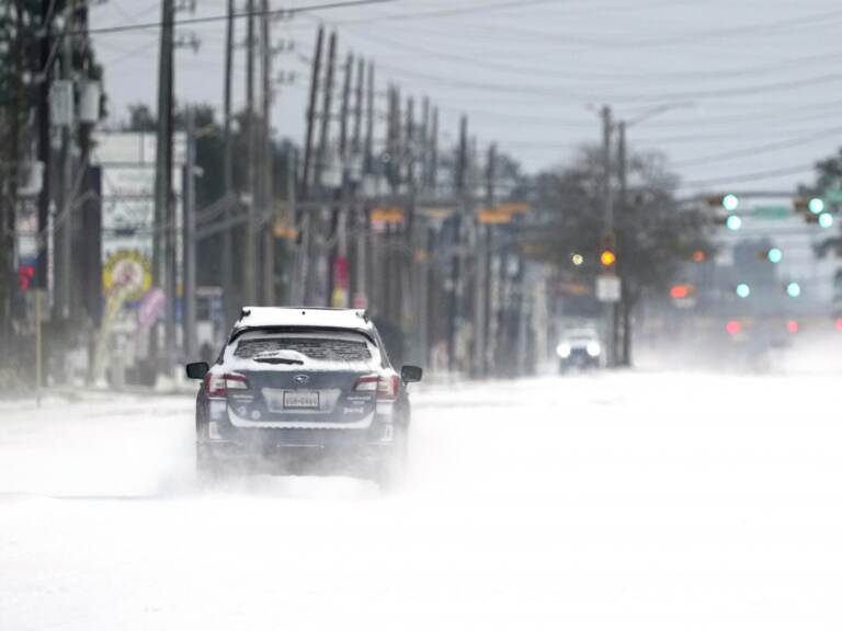 Vehicles drive on snow and sleet covered roads Monday, Feb. 15, 2021, in Spring, Texas. A winter storm dropping snow and ice sent temperatures plunging across the southern Plains, prompting a power emergency in Texas a day after conditions canceled flights and impacted traffic across large swaths of the U.S. (David J. Phillip / AP Photo)