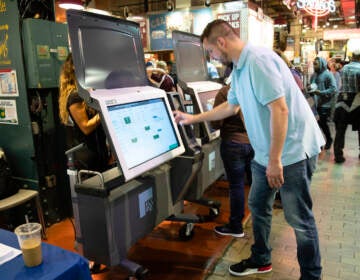 A City Commissioners staffer demonstrates the ExpressVote XL voting machine at Reading Terminal Market in 2019. (AP Photo/Matt Rourke, File)