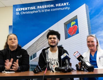 Mom Natali Rosario (left), 17 year-old Ivan (center) and pediatric neurosurgeon Dr. Tina Loven (right) spoke to the media about Ivan’s recovery a year after he was shot in the head near his high school, October 18, 2022. (Kimberly Paynter/WHYY)