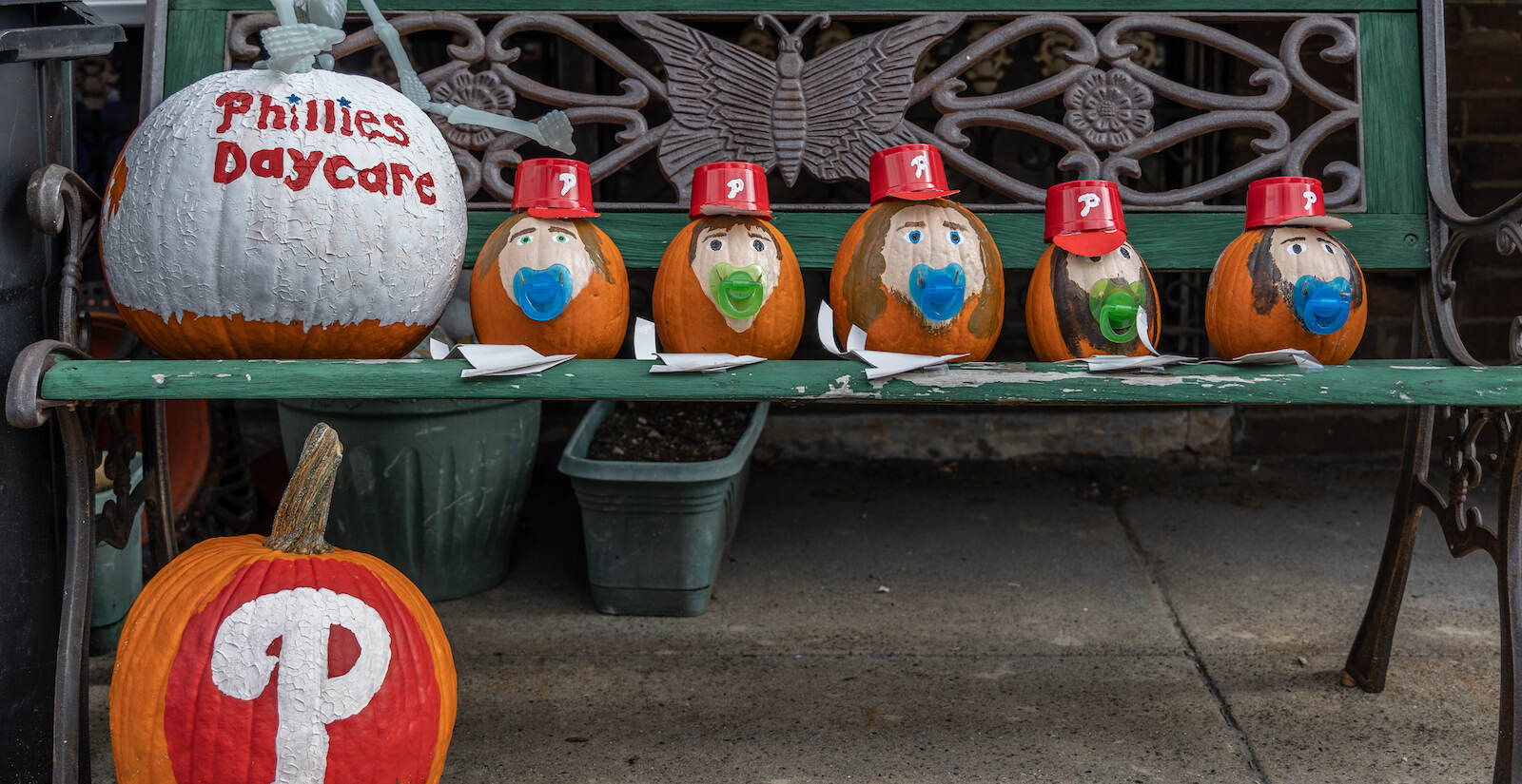 A pumpkin is decorated with the words ''Phillies daycare,' alongside pumpkins adorned with Phillies hats