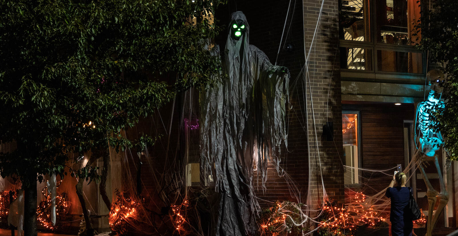 Towering figures are seen in a Halloween display outside a Graduate Hospital building