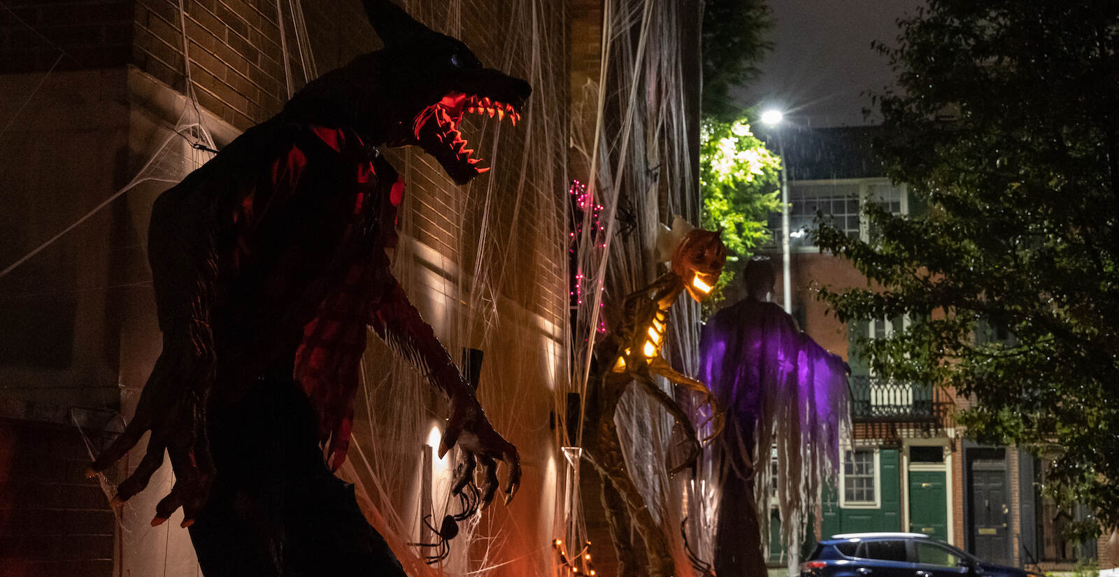 Towering figures are seen in a Halloween display outside a Graduate Hospital building