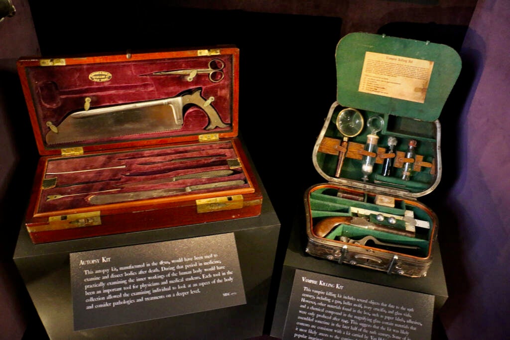 Two cases of surgical instruments are open on display stands.