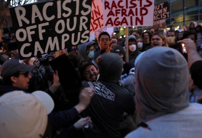 A man wearing a Proud Boys shirt fights with protesters ahead of an event featuring far-right group Proud Boys' founder Gavin McInnes at Pennsylvania State University in State College, Pa., on Monday. The event was canceled by Penn State officials, who cited ''the threat of escalating violence.'' (Leah Millis/Reuters)