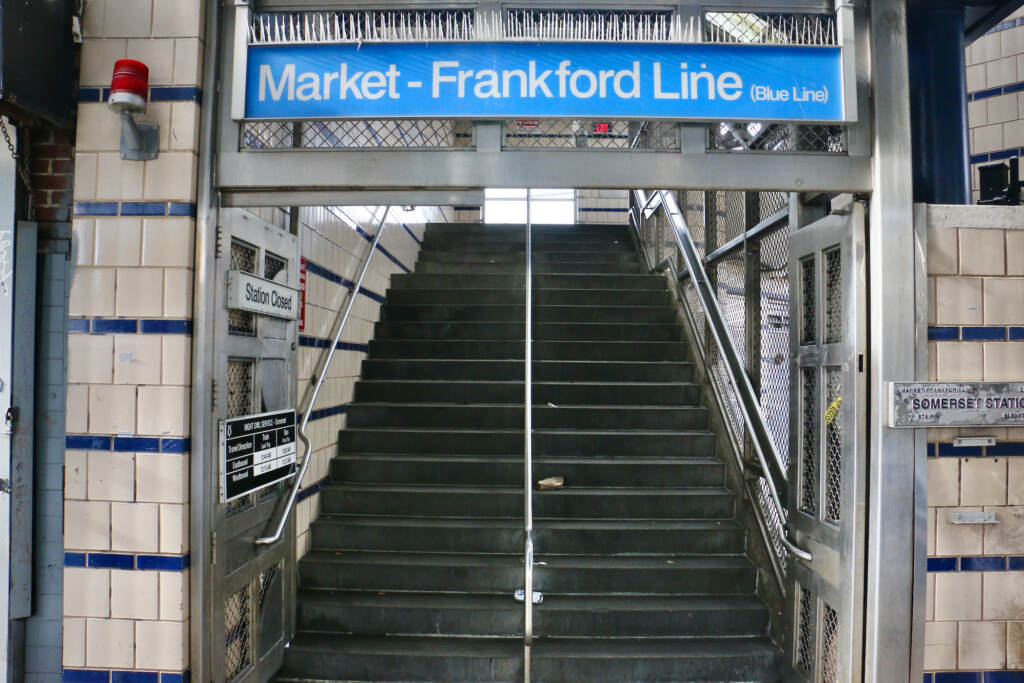 Stairs lead upwards. Above, a sign reads "Market-Frankford Line."