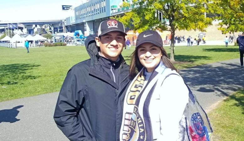 Valerie Davalos and Alex Fonseca stand in front of the Philadelphia Union's stadiumm in Chester. (Nick Kariuki/WHYY)