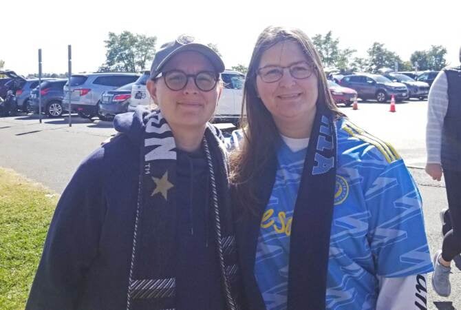 Stefanie (left) and Jennifer Schloo stand outside Subaru Park in Chester. Jennifer sees more cohesion in the Union's attack this season.
(Nick Kariuki/WHYY)