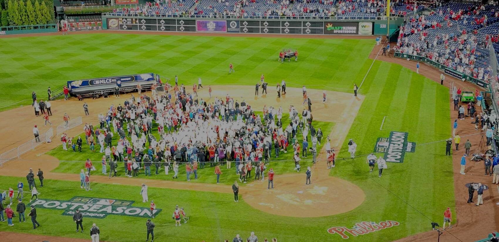 People gather on the baseball field.