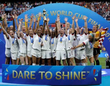 File photo: The United States' team celebrate with the trophy after winning the Women's World Cup final soccer match between against Netherlands at the Stade de Lyon in Decines, outside Lyon, France. As the nation celebrates the 50th anniversary of Title IX, a new poll finds Americans are split on how much progress has come from the landmark women's rights law. (AP Photo/Alessandra Tarantino, File)