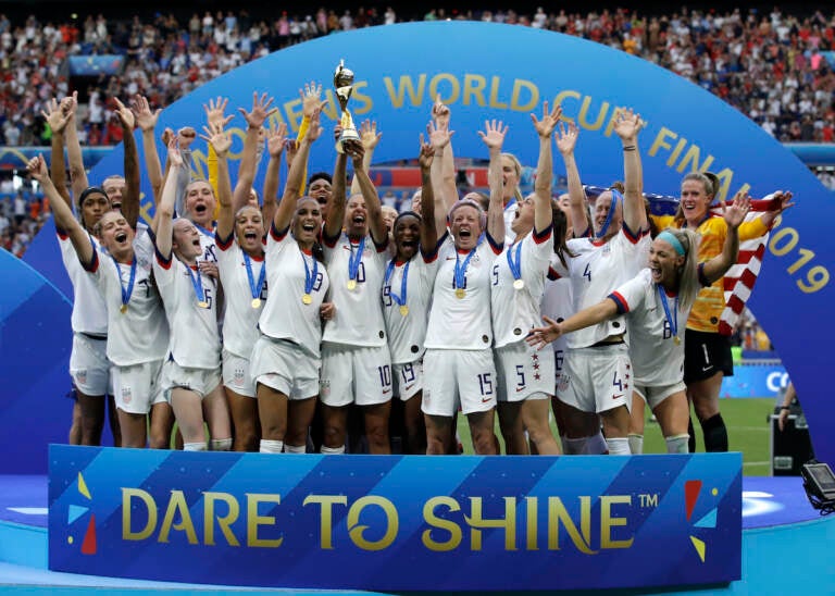 File photo: The United States' team celebrate with the trophy after winning the Women's World Cup final soccer match between against Netherlands at the Stade de Lyon in Decines, outside Lyon, France. As the nation celebrates the 50th anniversary of Title IX, a new poll finds Americans are split on how much progress has come from the landmark women's rights law. (AP Photo/Alessandra Tarantino, File)