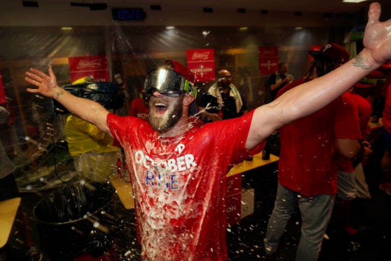 Philadelphia Phillies' Bryce Harper celebrates after the Phillies won against the Houston Astros to clinch a wild-card playoff spot, Monday, Oct. 3, 2022, in Houston. (AP Photo/David J. Phillip)