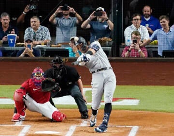 New York Yankees' Aaron Judge connects for a solo home run, his 62nd of the season, off as Texas Rangers catcher Sam Huff and umpire Randy Rosenberg look on in the first inning of the second baseball game of a doubleheader in Arlington, Texas, Tuesday, Oct. 4, 2022. With the home run, Judge set the AL record for home runs in a season, passing Roger Maris.  (AP Photo/Tony Gutierrez)