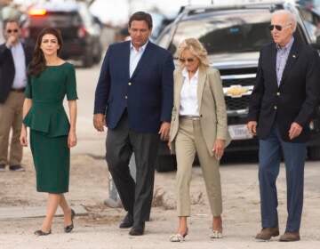 (From left) Florida's first lady Casey DeSantis, Gov. Ron DeSantis, first lady Jill Biden and President Joe Biden arrive at Fort Myers Beach, Fla., Wednesday, Oct. 5, 2022, to survey the damage caused by Hurricane Ian. (Saul Young/Knoxville News Sentinel via AP, Pool)