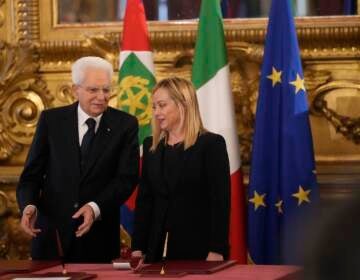 Italian President Sergio Mattarella is flanked by newly appointed Italian Premier Giorgia Meloni during the swearing in ceremony at Quirinal presidential palace in Rome, Saturday, Oct. 22, 2022, as Italy's first far-right-led government since the end of World War II takes office. (AP Photo/Alessandra Tarantino)