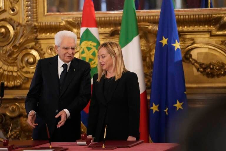 Italian President Sergio Mattarella is flanked by newly appointed Italian Premier Giorgia Meloni during the swearing in ceremony at Quirinal presidential palace in Rome, Saturday, Oct. 22, 2022, as Italy's first far-right-led government since the end of World War II takes office. (AP Photo/Alessandra Tarantino)