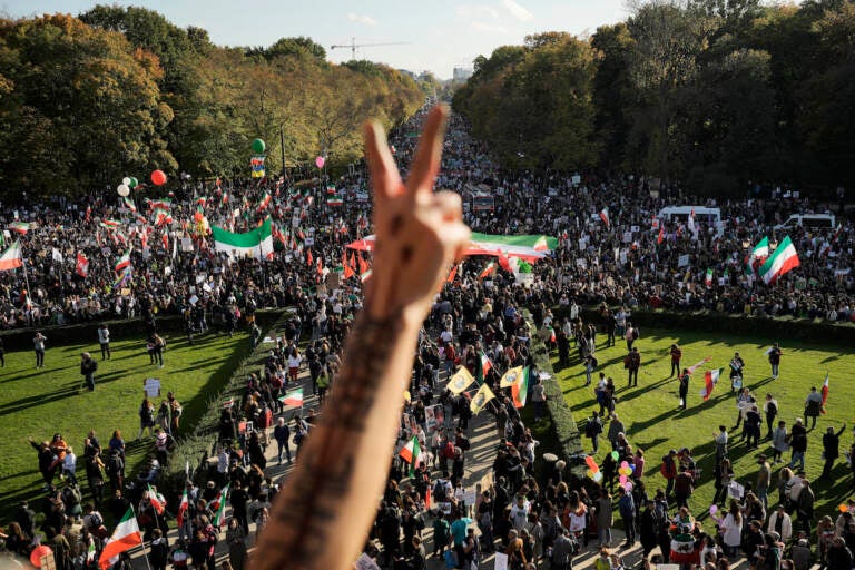 A man gestures as people attend a protest against the Iranian regime, in Berlin, Germany, Saturday, Oct. 22, 2022, following the death of Mahsa Amini in the custody of the Islamic republic's notorious ''morality police.'' (AP Photo/Markus Schreiber)