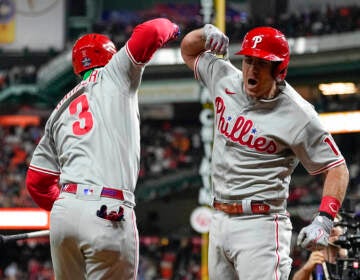 Two Phillies players do an elbow bump.