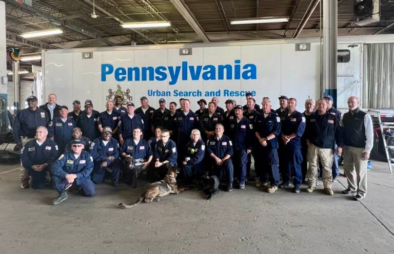 Pennsylvania Task Force 1 pose with Pa. Gov. Tom Wolf (far right) after returning to Philadelphia. (@PhillyFireDept/Twitter)