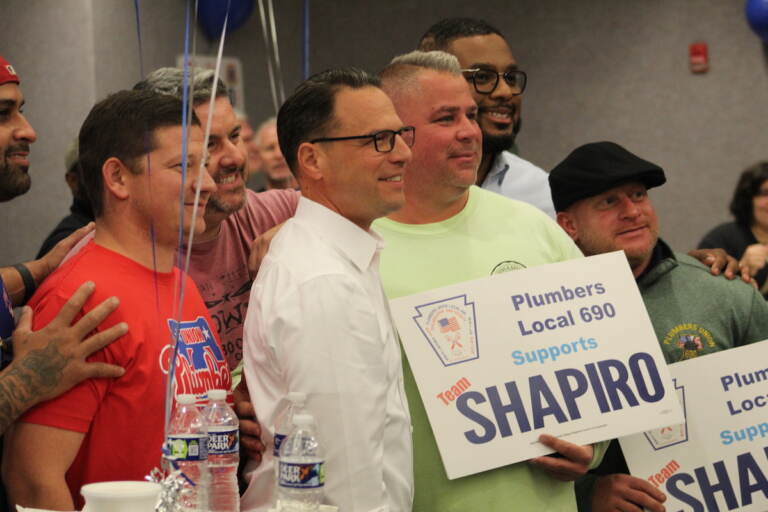 Democratic gubernatorial candidate Josh Shapiro posed for photos with some of his supporters while making an appearance in Philadelphia on Oct. 11, 2022. (Cory Sharber/WHYY)