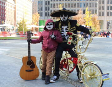 People who participated in a community bike ride on Sunday were encouraged to decorate their bicycles and to dress up as Catrinas or Calaveras. (Cory Sharber/WHYY)