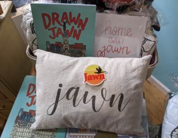 Pictured items include a jawn pillow from The Pillow Works, the Drawn Jawn coloring book by Katie Otte, a jawn sticker from South Fellini and a print that says 