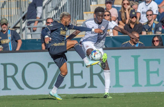 The Union's José Martínez and Toronto's Noble Okello attempt to gain control of the ball in the second half of the match. (Jonathan Wilson/WHYY)