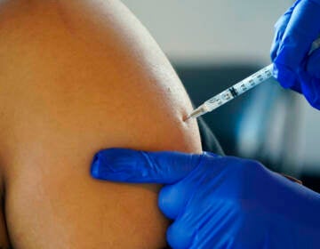 A Jackson, Miss., resident receives a Pfizer booster shot from a nurse at a vaccination site Feb. 8. (Rogelio V. Solis/AP)