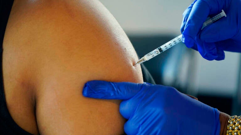 A Jackson, Miss., resident receives a Pfizer booster shot from a nurse at a vaccination site Feb. 8. (Rogelio V. Solis/AP)