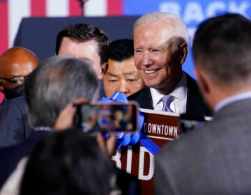 Biden is surrounded by people.