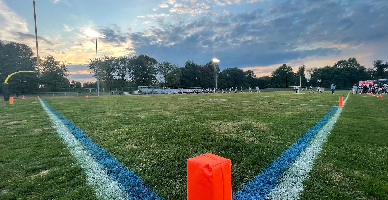 Players on a field are visible in the background.