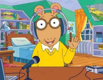 In a digital short previewing the podcast, Arthur shows his audio equipment and once again, his headphones are not on his actual ears. (PRX)