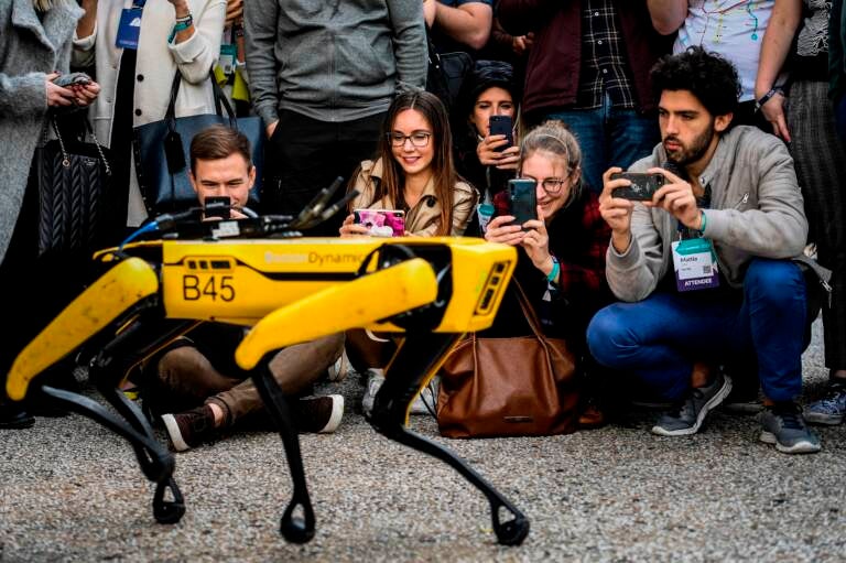 People take pictures and videos of the Boston Dynamics robot Spot during an event in Lisbon in 2019. (Patricia De Melo Moreira/AFP via Getty Images)