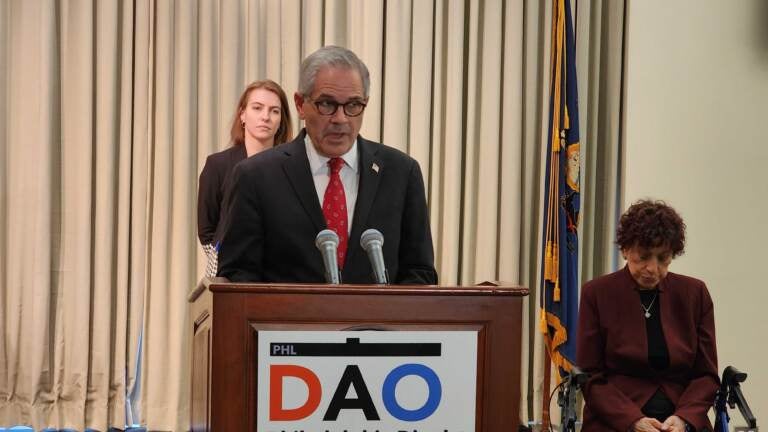 DA Larry Krasner speaks at a podium.