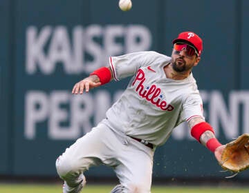 Philadelphia Phillies right fielder Nick Castellanos (8) makes a diving catch against Atlanta Braves catcher William Contreras during the ninth inning in Game 1 of a National League Division Series baseball game, Tuesday, Oct. 11, 2022, in Atlanta. The Philadelphia Phillies won 7-6. (AP Photo/John Bazemore)