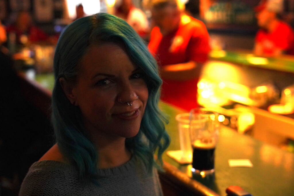 A woman sits at a bar.