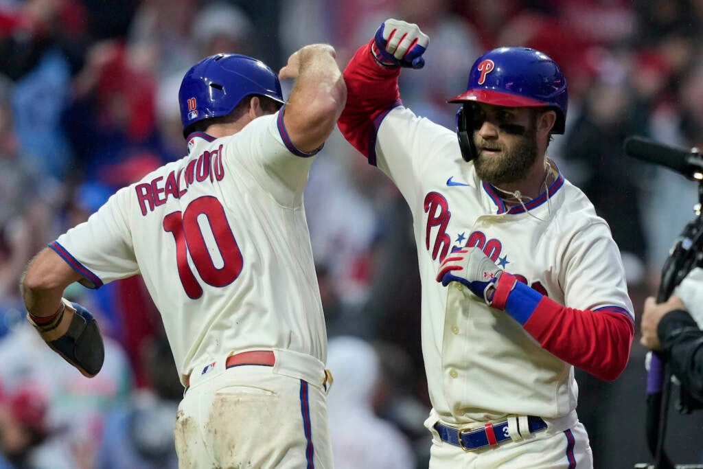 Bryce Harper celebrates with J.T. Realmuto during the NLCS
