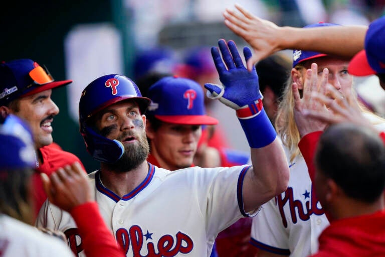 Philadelphia Phillies' Rhys Hoskins, center, celebrates with
