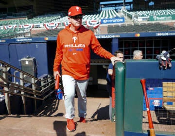 Philadelphia Phillies manager Rob Thomson steps out of the dugout for a workout ahead of Game One of the National League Division baseball playoff game against the Atlanta Braves, Monday, Oct. 10, 2022, in Atlanta. (AP Photo/John Bazemore)