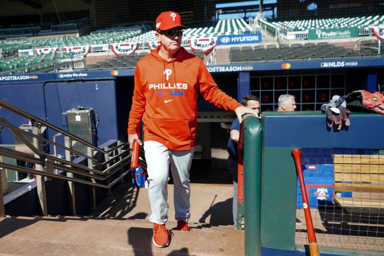 Philadelphia Phillies manager Rob Thomson steps out of the dugout for a workout ahead of Game One of the National League Division baseball playoff game against the Atlanta Braves, Monday, Oct. 10, 2022, in Atlanta. (AP Photo/John Bazemore)